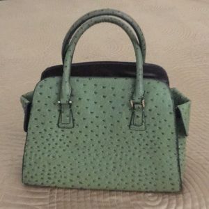 Green leather handbag with side pockets